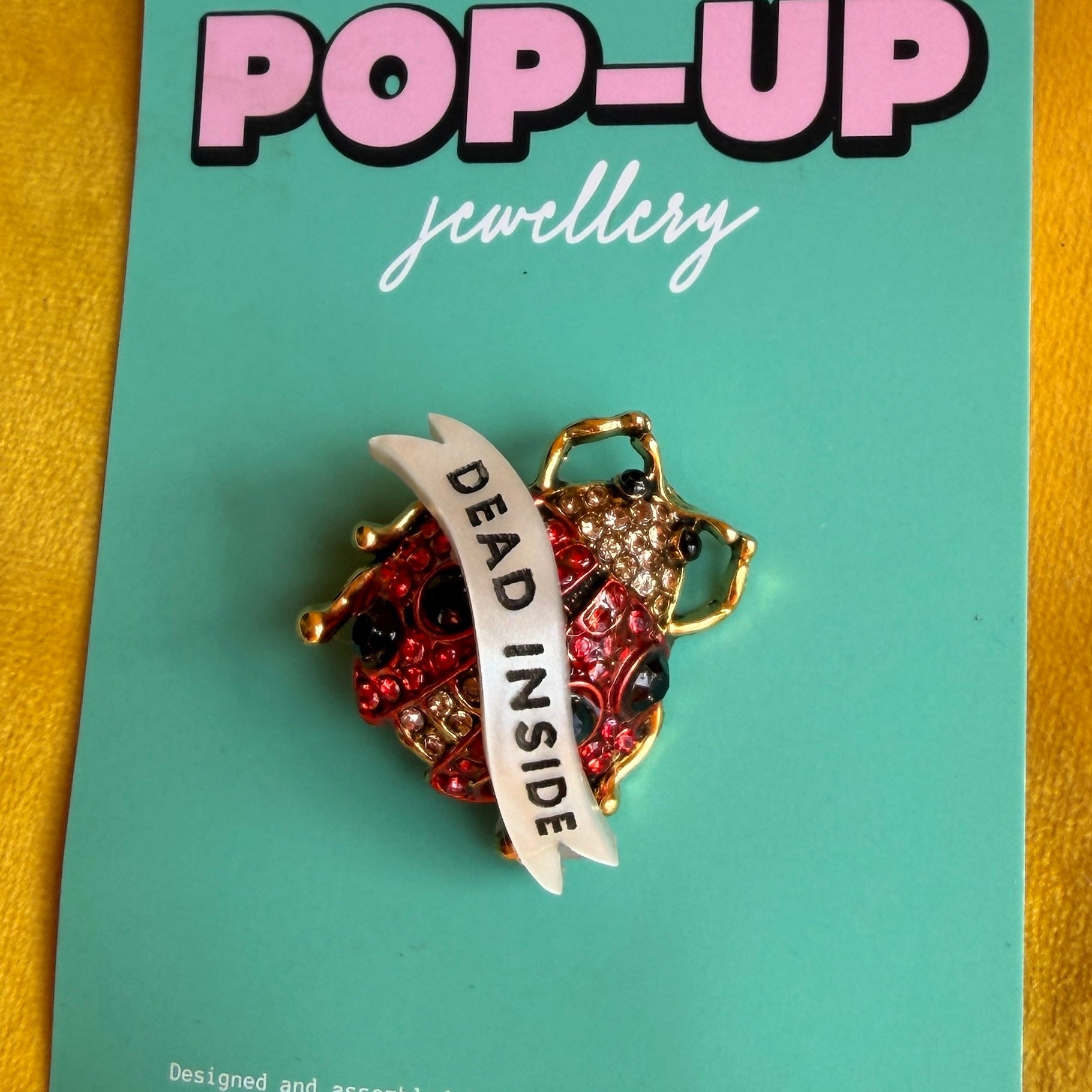 Dead Inside, ladybird pin
