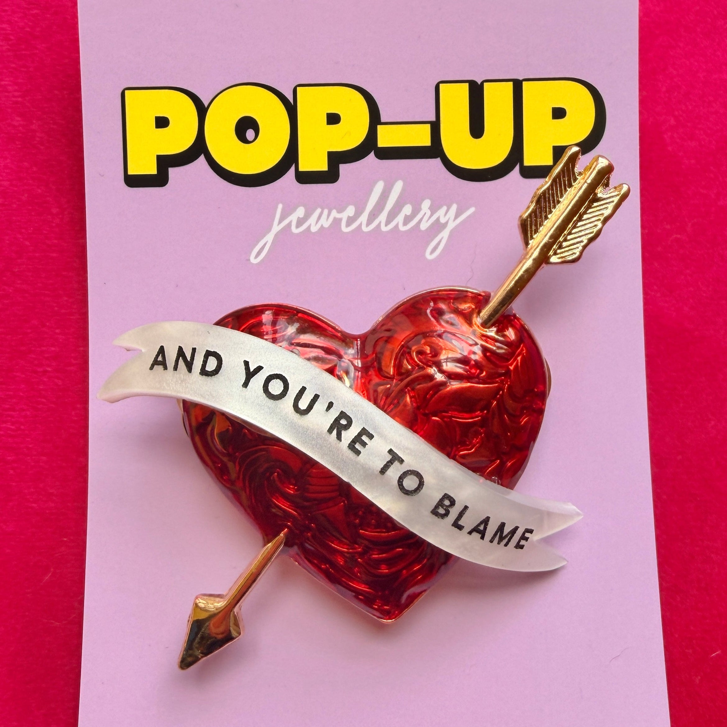 SHOT THROUGH THE HEART… and you’re to blame. Enamel pin.