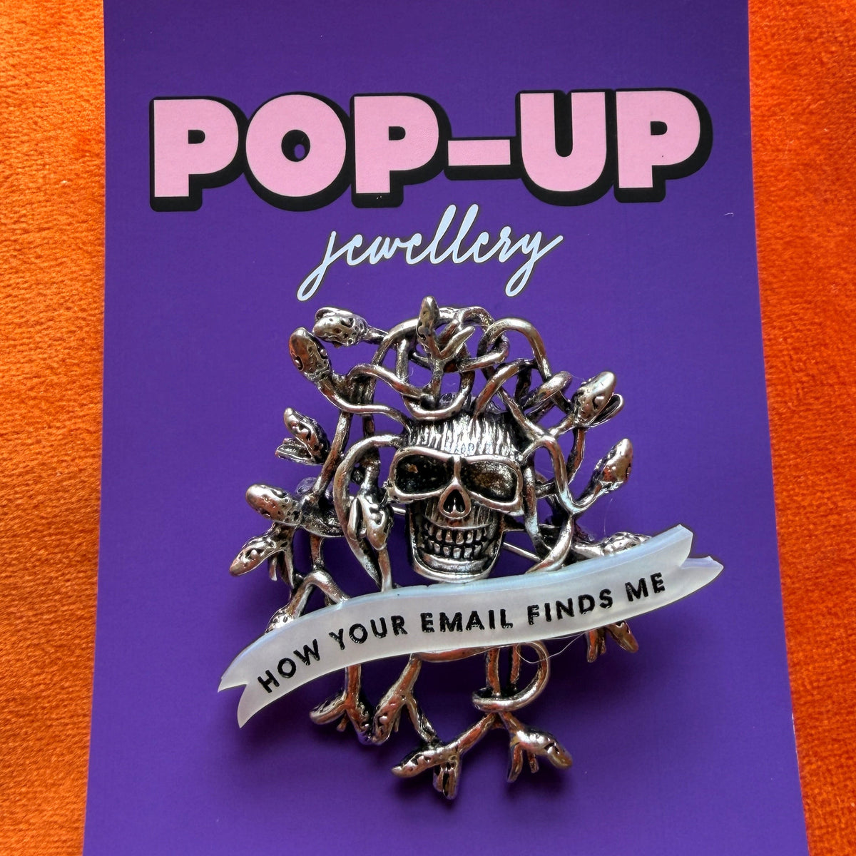 How your email finds me, withered up skull pin.