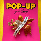 Menopausal goldfish pin.