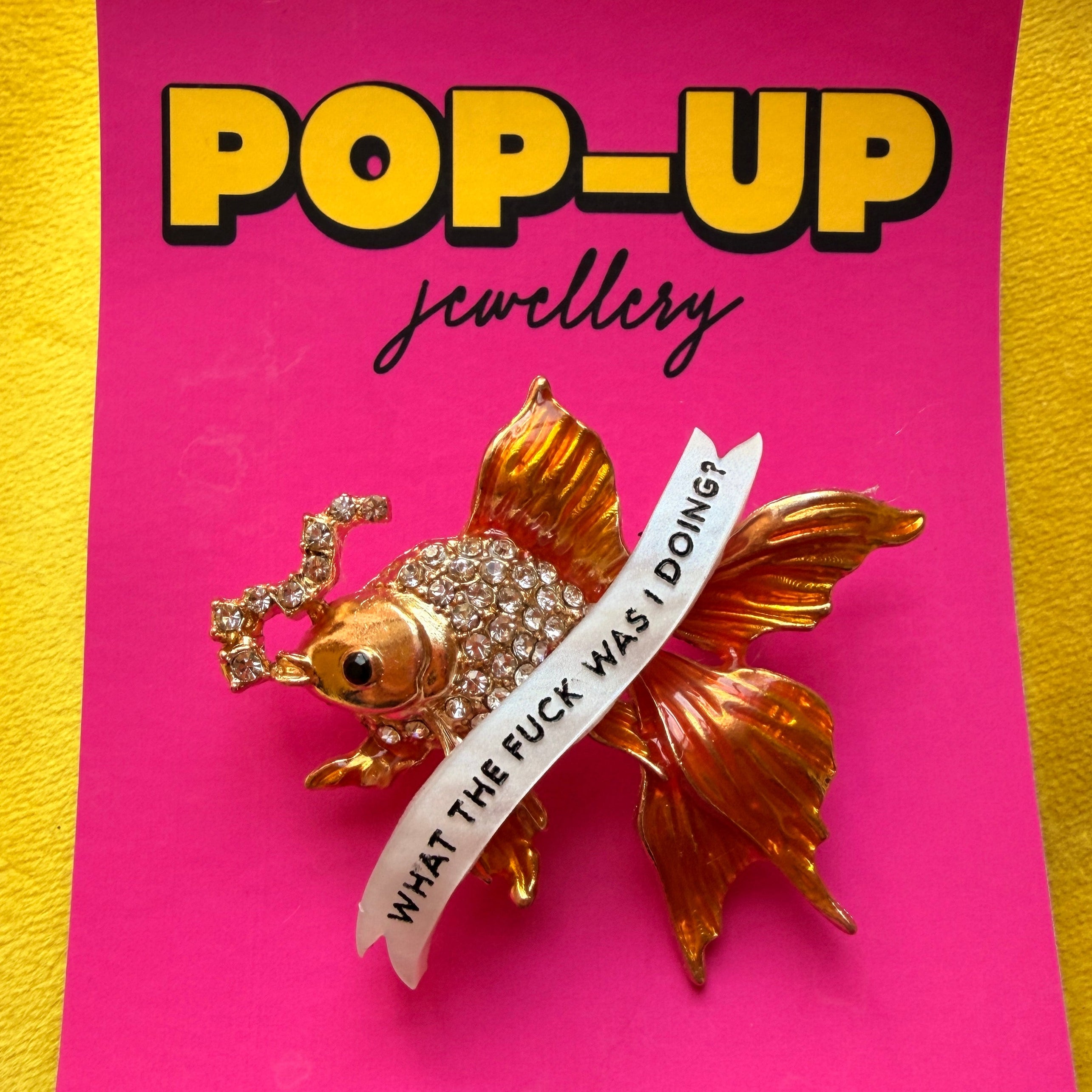 Menopausal goldfish pin.