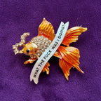 Menopausal goldfish pin.