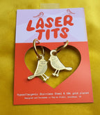 Bird-shaped earrings on a 'Laser Tits' branded card with gold plating details.