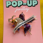 I am a fucking professional, diamanté fish pin