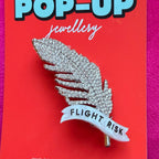 Flight Risk, Feather diamanté pin