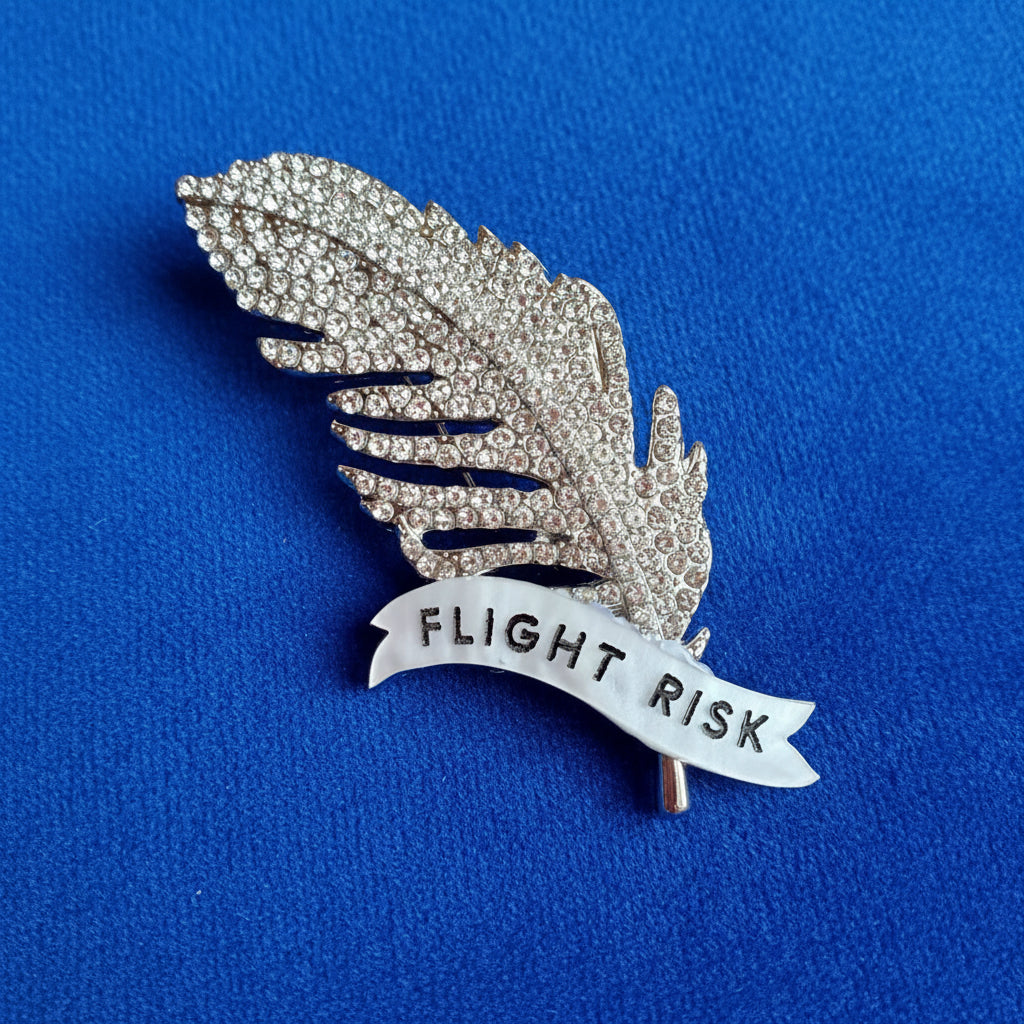 Flight Risk, Feather diamanté pin