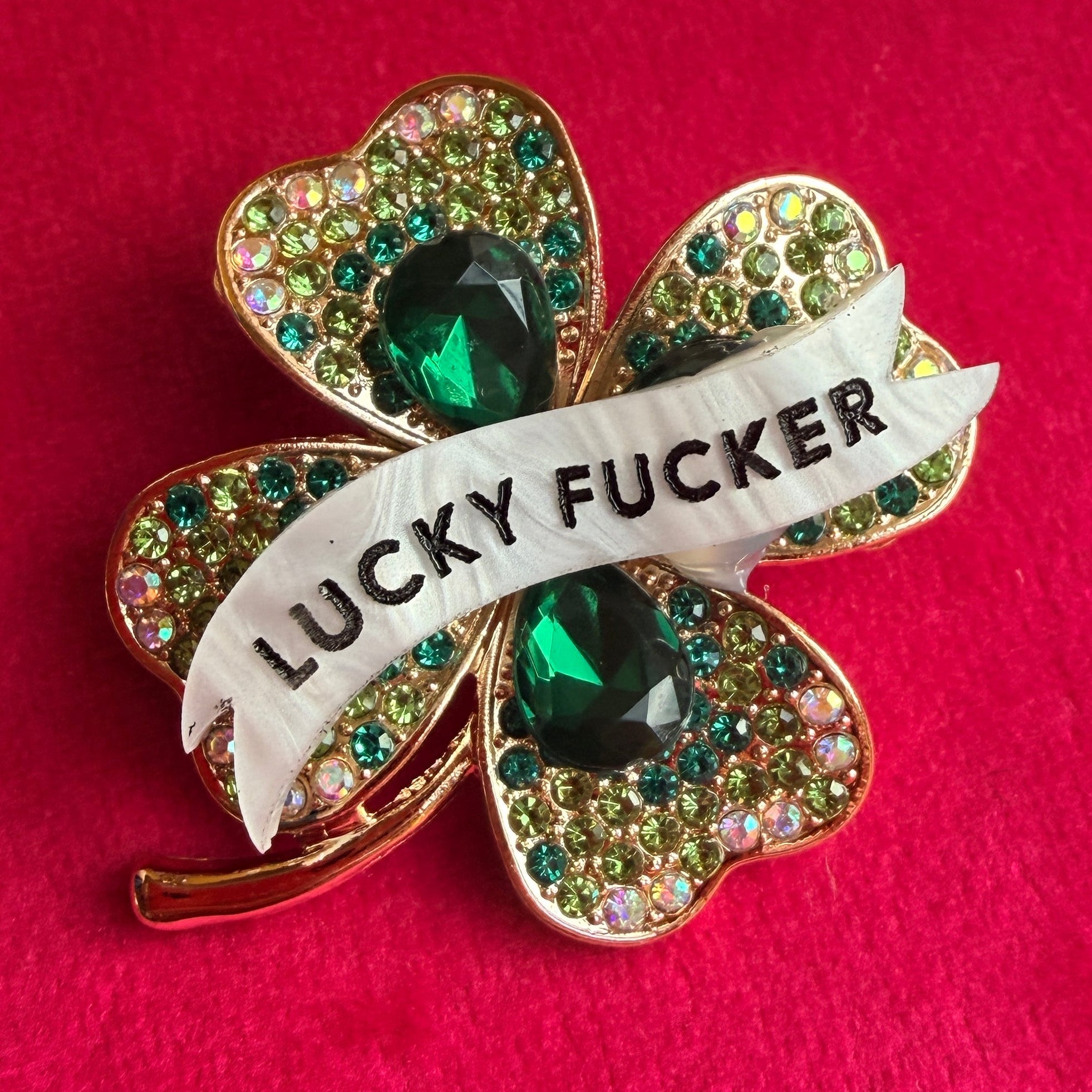 LUCKY FUCKER, diamanté shamrock pin.