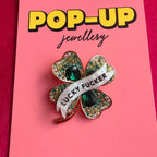 LUCKY FUCKER, diamanté shamrock pin.